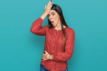 Young hispanic woman wearing casual clothes surprised with hand on head for mistake, remember...
