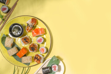 Sushi rolls on yellow background