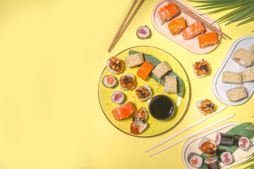 Sushi rolls on yellow background