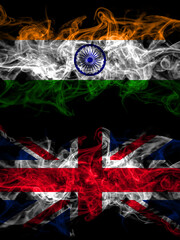 India, Indian vs United Kingdom, Great Britain, British smoky mystic flags placed side by side. Thick colored silky abstract smoke flags.