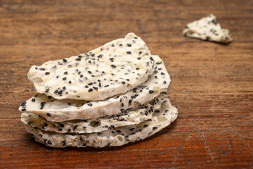 slices (chips) of dried white dragon fruit  against rustic weathered wood