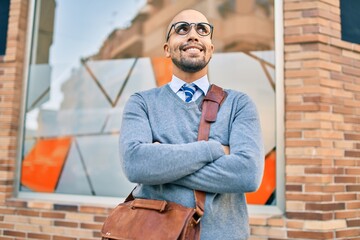 Young african american businessman smiling happy walking at the city.
