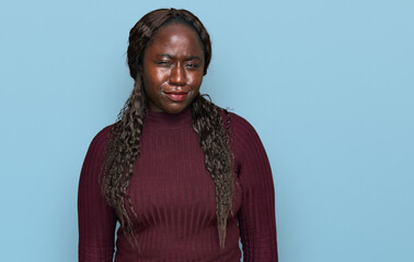 Young african woman wearing casual winter sweater skeptic and nervous, frowning upset because of problem. negative person.