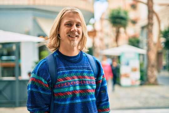 Young scandinavian student man smiling happy standing at the city.