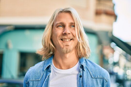 Young Blond Scandinavian Man Smiling Happy Standing At The City.