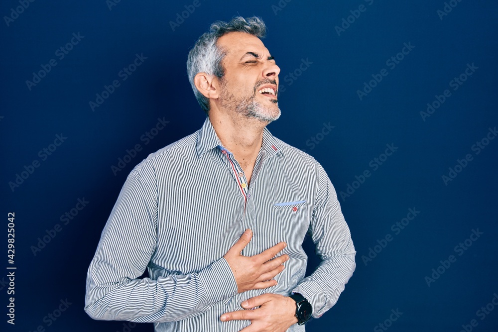 Sticker handsome middle age man with grey hair wearing business shirt with hand on stomach because nausea, p