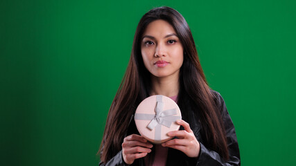 Young woman is very surprised and happy with her gift - studio photography