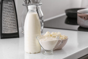 Different dairy products on table in kitchen