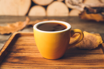 Board with cup of coffee on wooden background, closeup