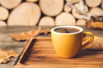 Board with cup of coffee on wooden background, closeup