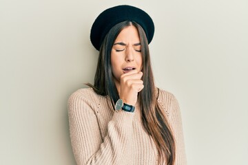 Young brunette woman wearing french look with beret feeling unwell and coughing as symptom for cold or bronchitis. health care concept.