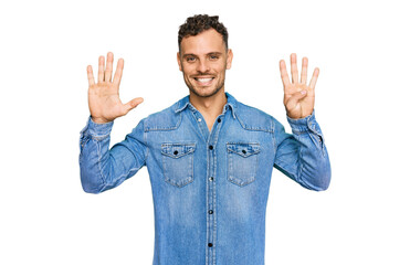 Young hispanic man wearing casual denim jacket showing and pointing up with fingers number nine...