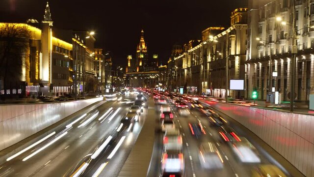 Night timelapse of the urban city street with busy highway and neon lights of Moscow, Russia
