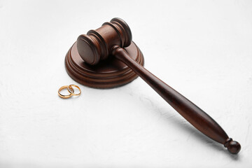 Judge's gavel with rings on light background