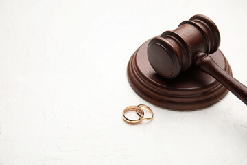 Judge's gavel with rings on light background