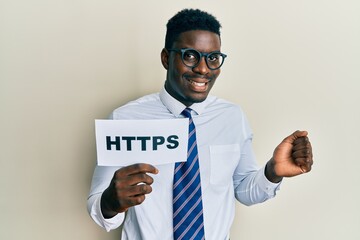 Handsome black man holding https privacy url screaming proud, celebrating victory and success very excited with raised arm