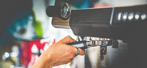 barista hand preparing coffee on coffee machine
