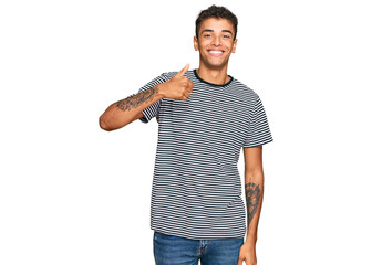 Young handsome african american man wearing casual clothes doing happy thumbs up gesture with hand. approving expression looking at the camera showing success.
