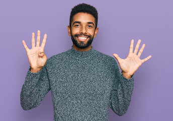 Young african american man wearing casual clothes showing and pointing up with fingers number nine...