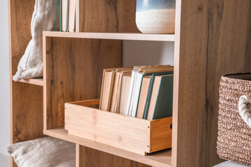 Fototapeta na wymiar Wooden shelf with books and decor, closeup