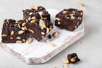 chocolate Fudge with salted peanuts on the wood board