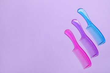 Plastic hair combs on color background