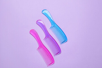 Plastic hair combs on color background