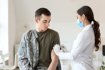 Fototapeta premium Doctor vaccinating patient against covid-19 in clinic