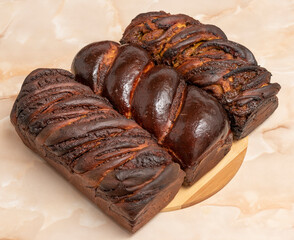 three chocolate pastry bread on a wooden table