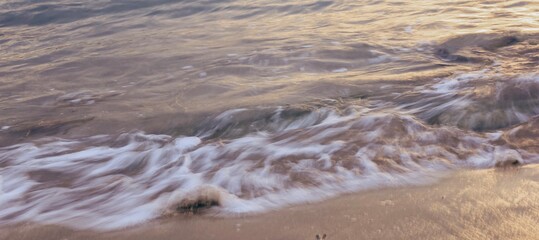 Blurred abstract natural background of sea water with waves and foam. Motion blur. Nature. Banner.	