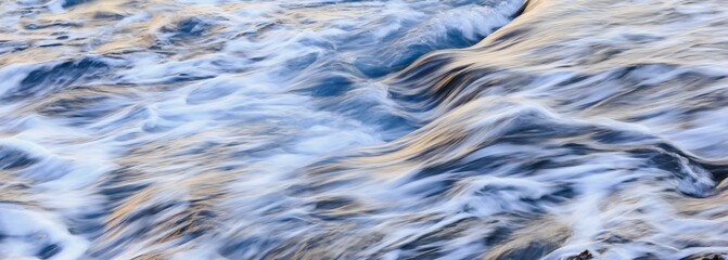 Blurred abstract natural background of sea water with waves and foam. Motion blur. Nature. Banner.	