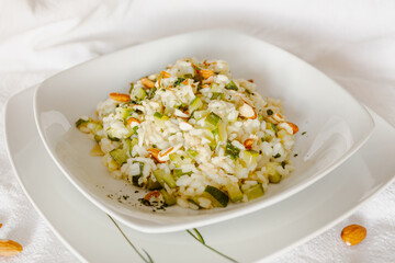 Vegan zucchini risotto with almonds in a white ceramic dish-1