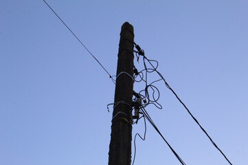 Electric power pole with wires and blue sky background