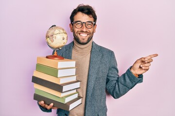 Handsome man with beard geography teacher smiling happy pointing with hand and finger to the side