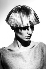 Elegant beautiful blonde woman posing in studio, wearing fashionable dress