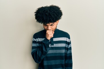 Fototapeta na wymiar Young african american man with afro hair wearing casual clothes feeling unwell and coughing as symptom for cold or bronchitis. health care concept.