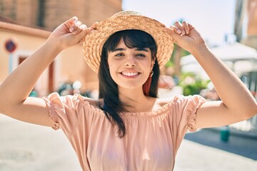 Young hispanic tourist girl wearing summer style walking at the city.