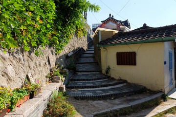 Vintage rustic a sloped steps along with flower bed ,lined with traditional house in Seoul ,South Korea.