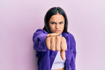 Young brunette woman wearing casual clothes pointing displeased and frustrated to the camera, angry and furious with you