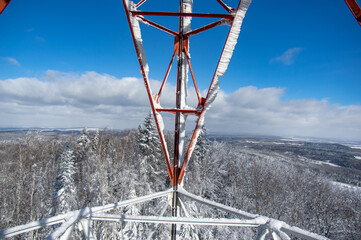 Tower with antennas connection in the mountains against the blue sky