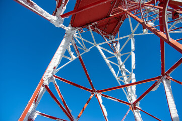 Tower with antennas connection in the mountains against the blue sky