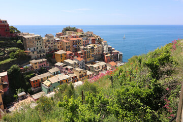 Fototapeta na wymiar Manarola Italy is a very colorful town that hangs on the mountainside with many vineyards and is one of five towns that make up the cinque terre region.