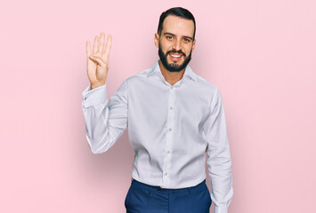 Fototapeta premium Young man with beard wearing business shirt showing and pointing up with fingers number four while smiling confident and happy.