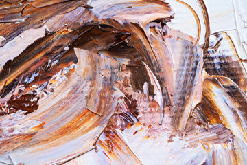 .Embossed pasty oil paints and reliefs. Primary colors: brown, white, pink, orange. Abstract art. Mix of paints.