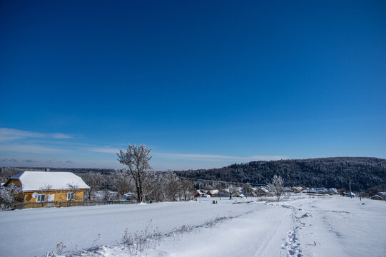 Panorama of a winter village covered with snow