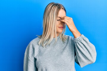 Beautiful blonde woman wearing casual clothes tired rubbing nose and eyes feeling fatigue and headache. stress and frustration concept.