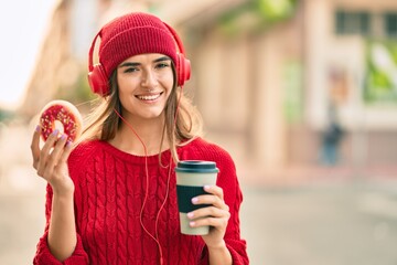 Young hispanic woman having breakfast using headphones at the city.