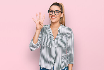 Young caucasian woman wearing business shirt and glasses showing and pointing up with fingers...