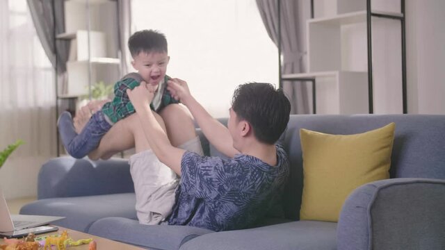 Young Asian Man Father Playing With His Son At Home
