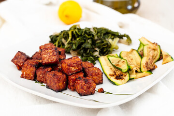 Marinated tempeh baked with vegetables. Vegan recipe